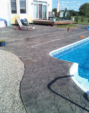 swimming pool in dexter, mi with stamped pool deck random stone style