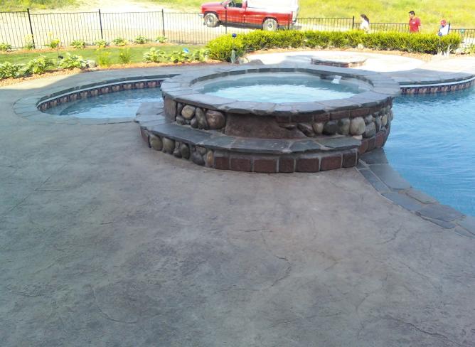 spill over spa with bluestone coping in northville, mi textured stamp concrete